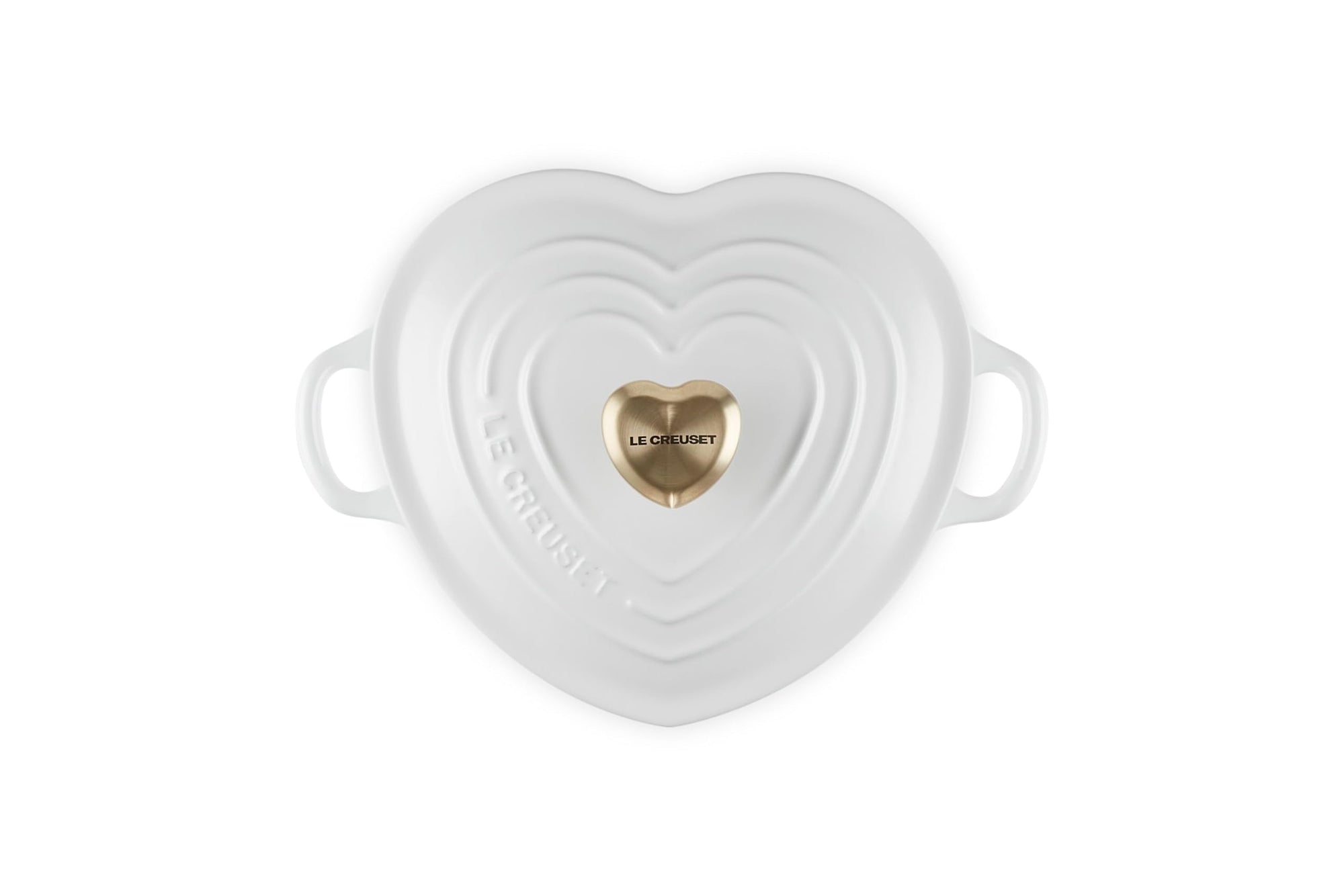 Top view of white heart shaped 1.25 qt cocotte with handles and a light gold heart knob displayed on a white background