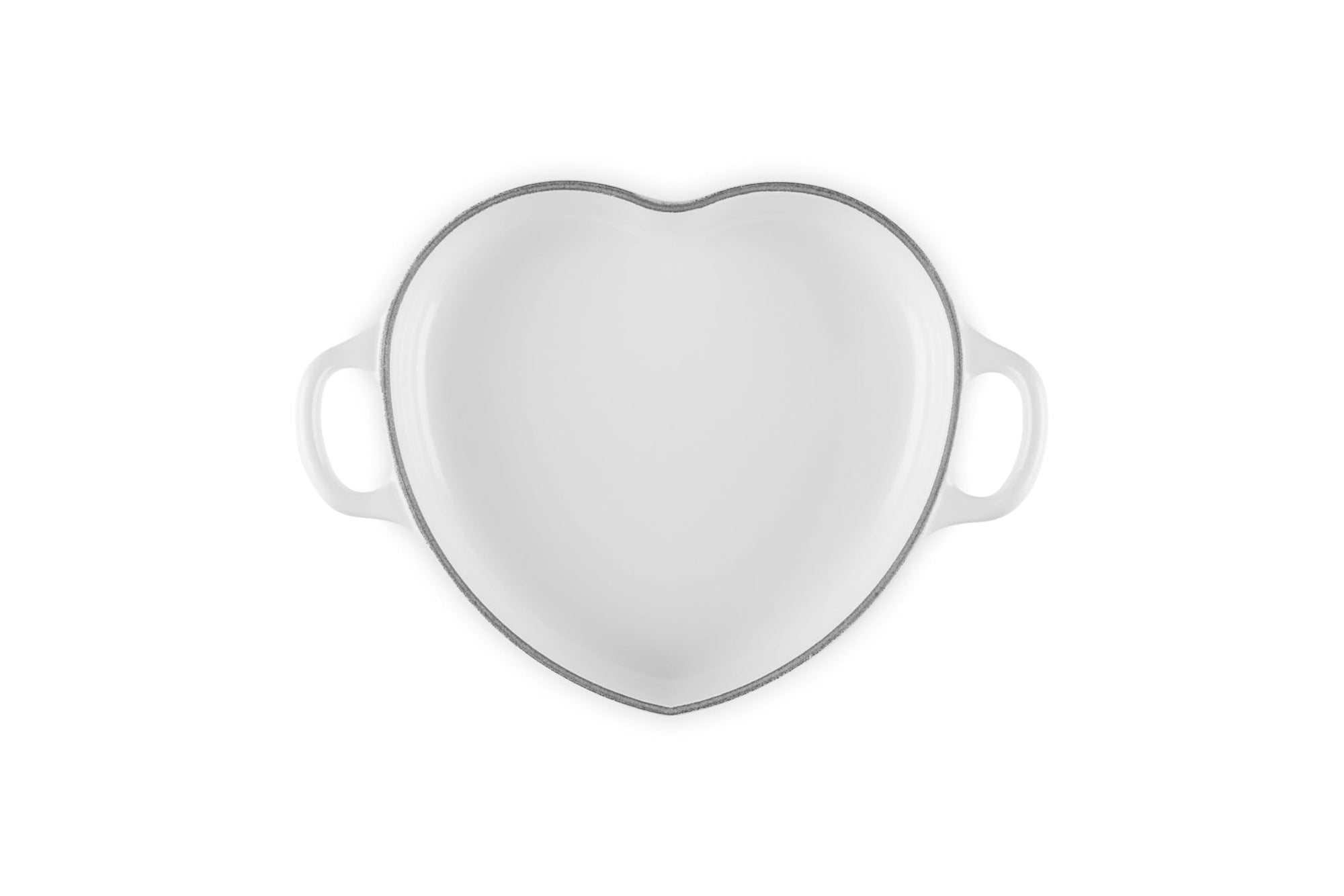 Top view of white heart shaped 1.25 qt cocotte with handles displayed on a white background