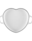 Top view of white heart shaped 1.25 qt cocotte with handles displayed on a white background
