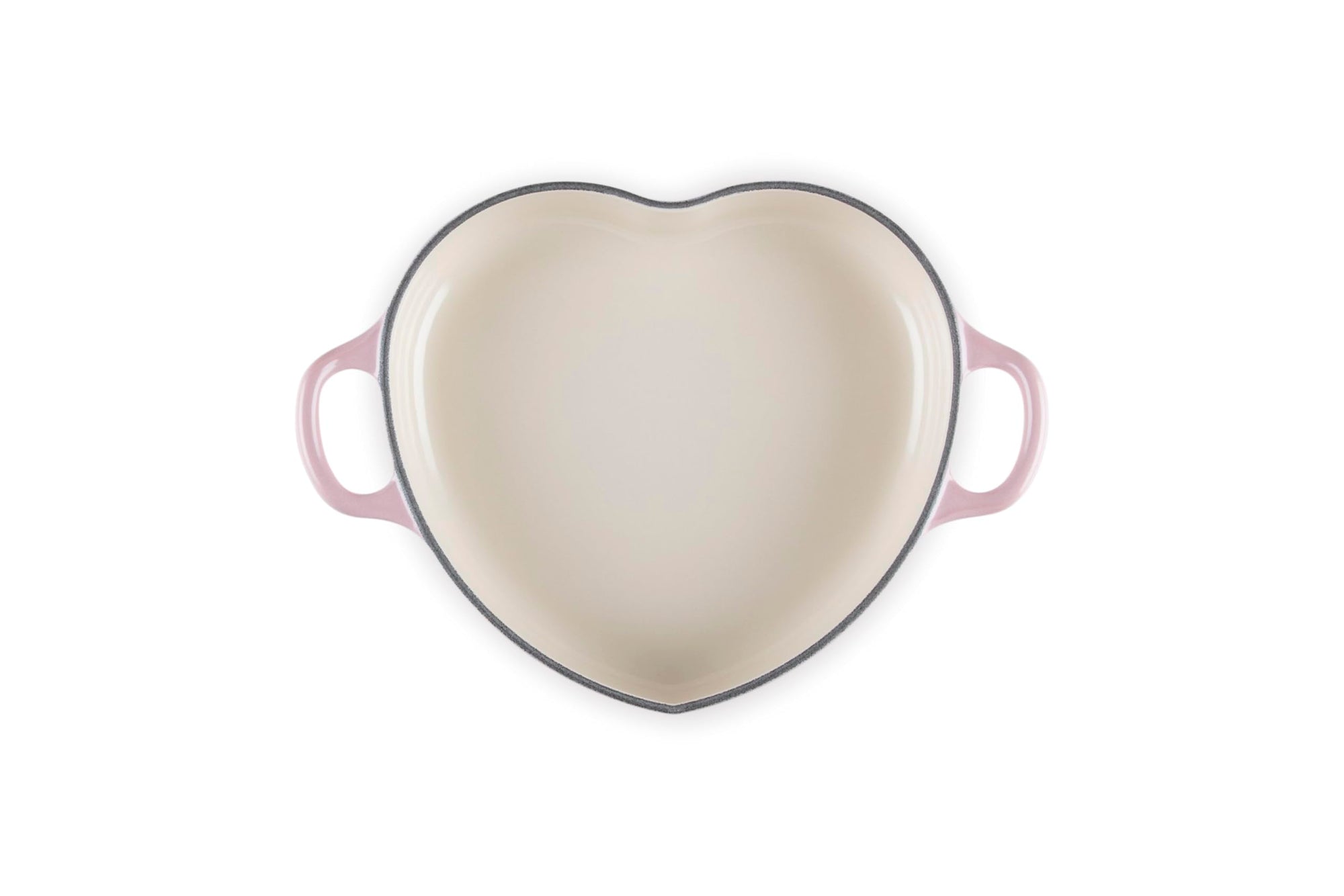 Top view of chiffon pink heart shaped 1.25 qt cocotte with handles displayed on a white background