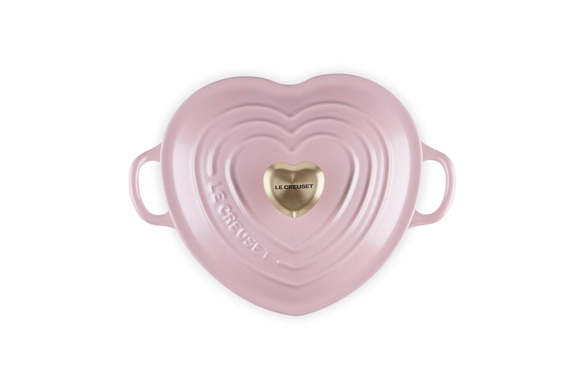 Top view of chiffon pink heart shaped 1.25 qt cocotte with handles and a light gold heart knob displayed on a white background