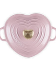 Top view of chiffon pink heart shaped 1.25 qt cocotte with handles and a light gold heart knob displayed on a white background