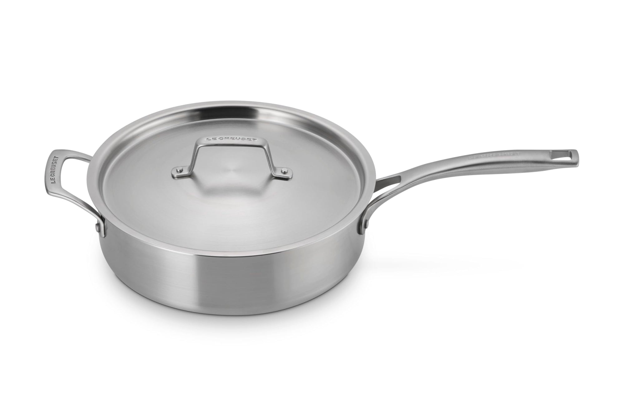 Le Creuset stainless steel saucepan with handles and lid displayed on a white background