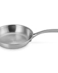Le Creuset stainless saucepan with handles displayed on a white background