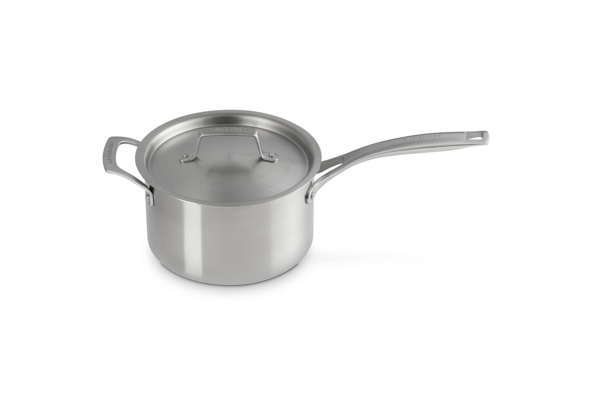 Le Creuset stainless steel pot with handles and lid displayed on a white background