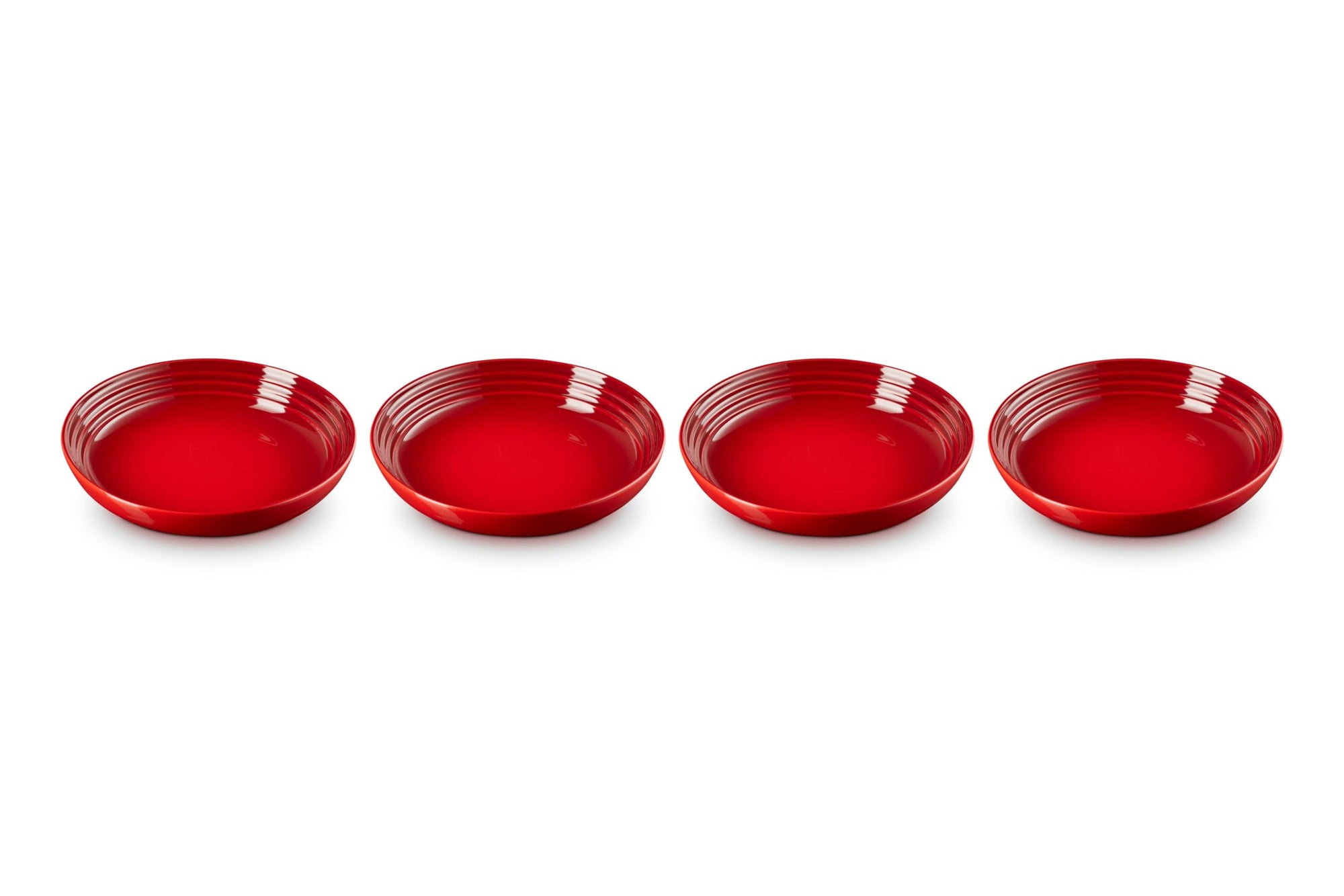 Four red ceramic bowls on a white background