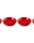 Four red ceramic bowls on a white background