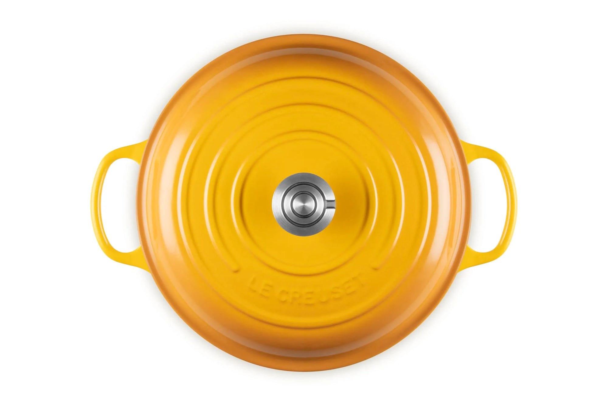 Top-down view of a Le Creuset round enameled cast iron pot in a vibrant yellow-orange color, featuring two side handles and a silver metal knob in the center, set against a plain white background.