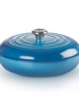 A blue enameled cast iron Dutch oven with a matching lid and silver metal knob, shown on a clean white background.