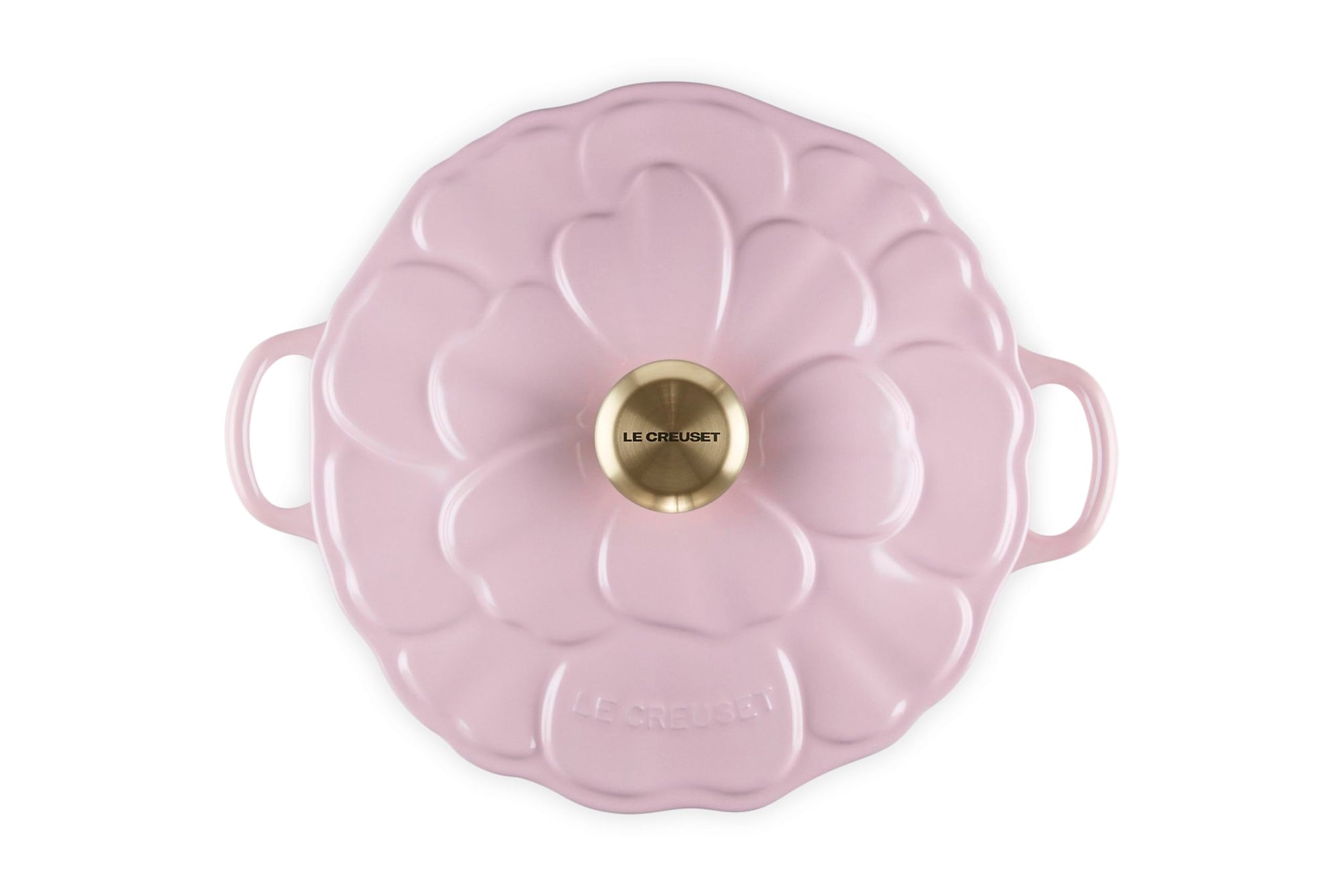 Pink enameled cast iron casserole dish with floral lid design on a white background