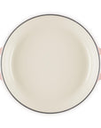 Round enamel pan with peche handles on a white background