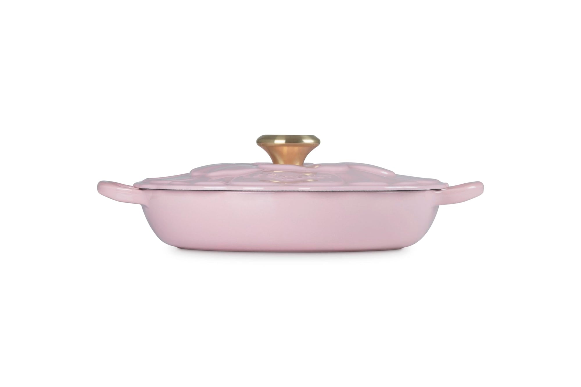 Pink casserole dish with gold knob on a white background