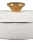 White ceramic dish with a gold knob on a white background
