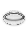 A round stainless steel grill press with a curved handle, featuring engraved text reading 'LE CREUSET' and 'EST. FRANCE 1925' on a white background.