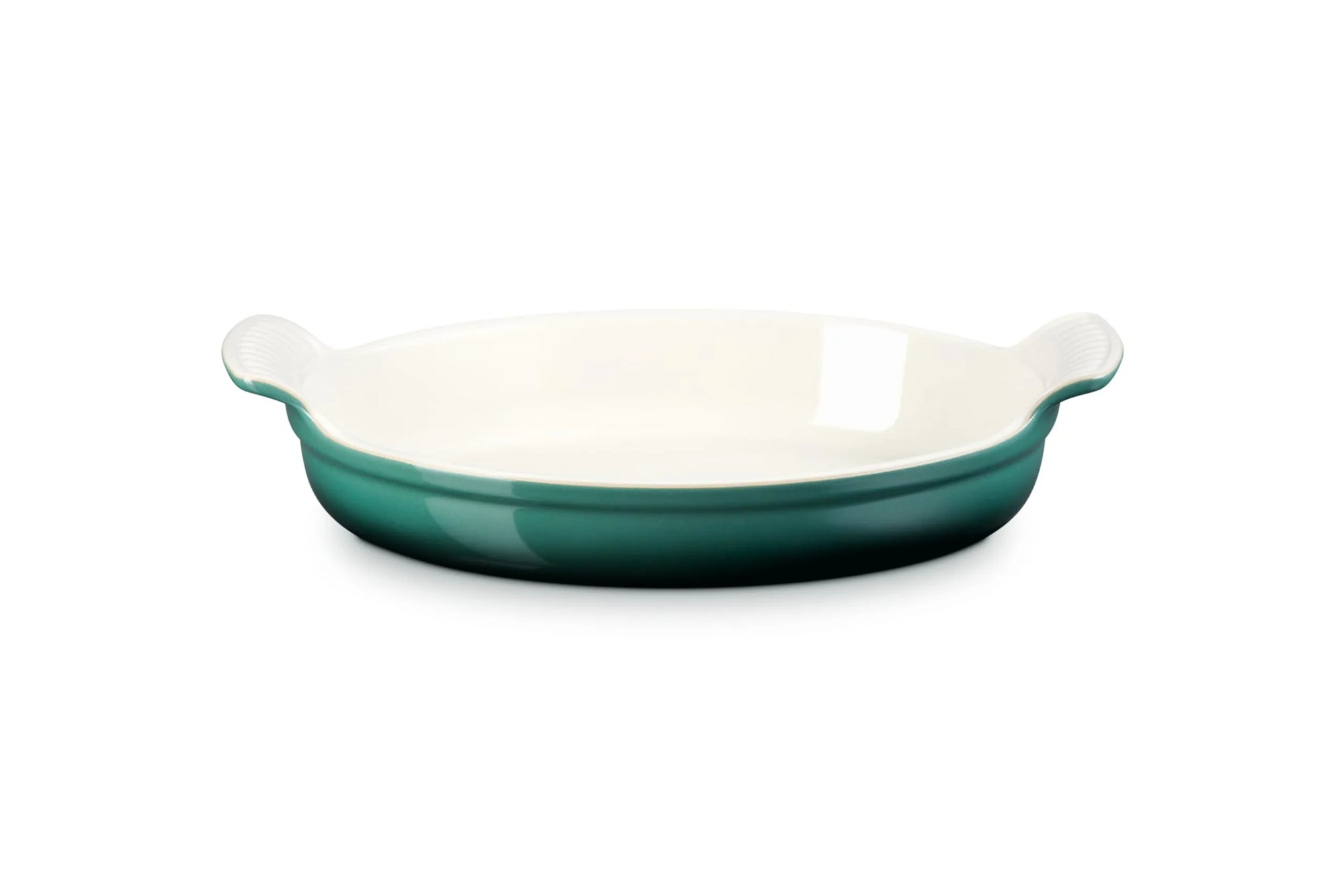 An oval ceramic baking dish with a glossy Artichaut exterior and a cream-colored interior, featuring small side handles, shown on a plain white background.