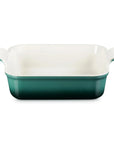 A rectangular ceramic baking dish with a white interior and a Artichaut exterior, featuring small side handles on a plain white background.
