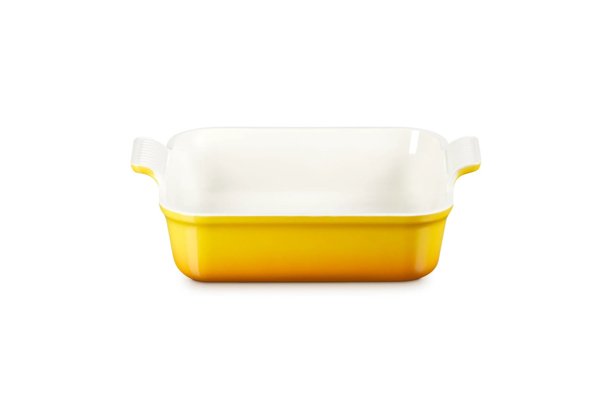 A rectangular ceramic baking dish with a yellow exterior and a white interior, featuring small side handles on a clean white background.