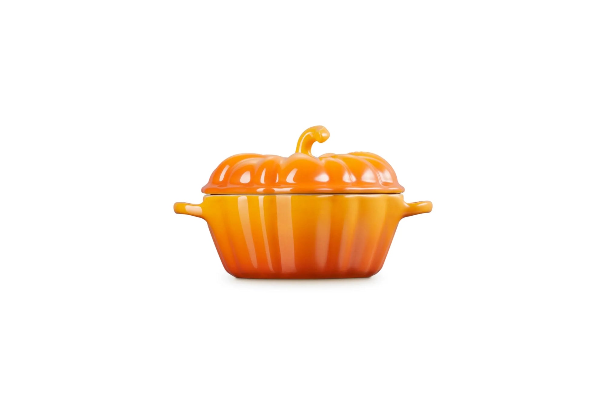 Side view of a persimmon cast-iron pumpkin-shaped lidded cocotte with side handles, shown on a plain white background.