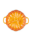 A persimmon enameled cast iron Dutch oven lid with a ribbed pumpkin-like design and side handles, shown from a top-down view on a white background.