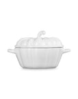 Side view of a white cast-iron pumpkin-shaped lidded cocotte with side handles, shown on a plain white background.