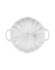 A white enameled cast iron Dutch oven lid with a ribbed pumpkin-like design and side handles, shown from a top-down view on a white background.