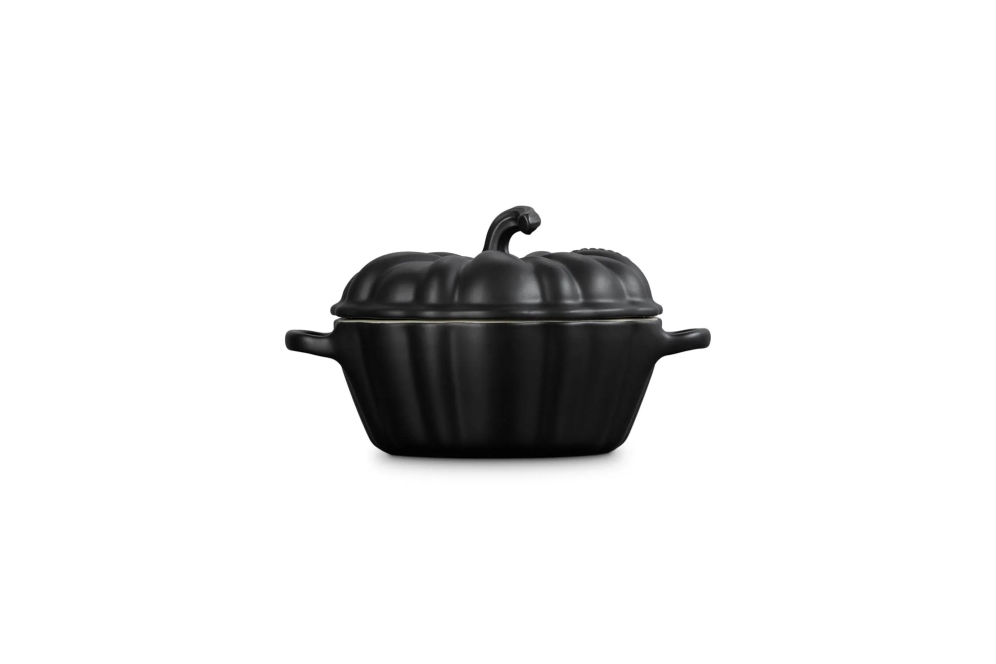 Side view of a black cast-iron pumpkin-shaped lidded cocotte with side handles, shown on a plain white background.