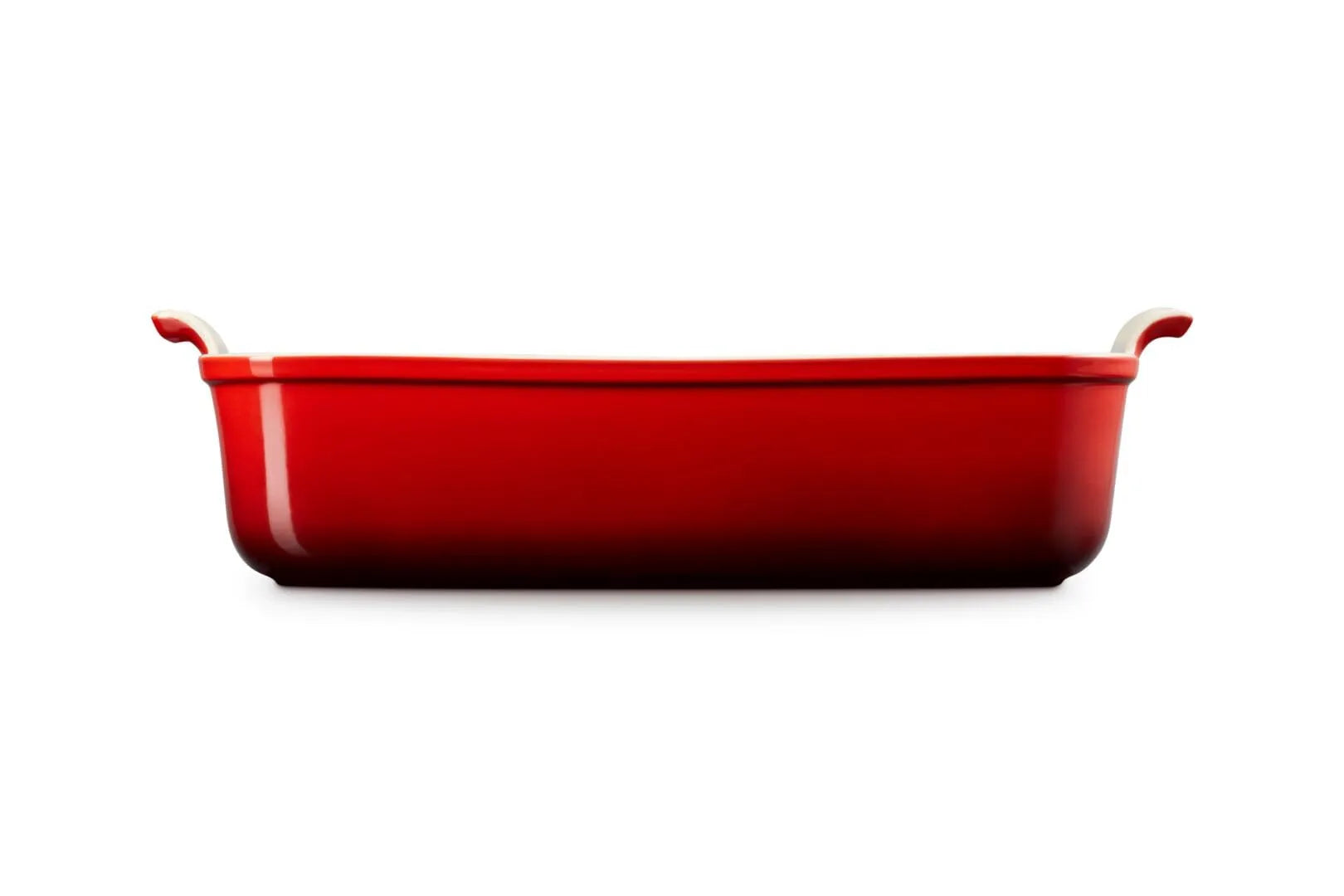 Side view of a red rectangular baking casserole dish with two small loop handles on the sides, shown from a front-facing perspective on a solid white background.