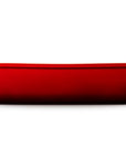 Side view of a red rectangular baking casserole dish with two small loop handles on the sides, shown from a front-facing perspective on a solid white background.