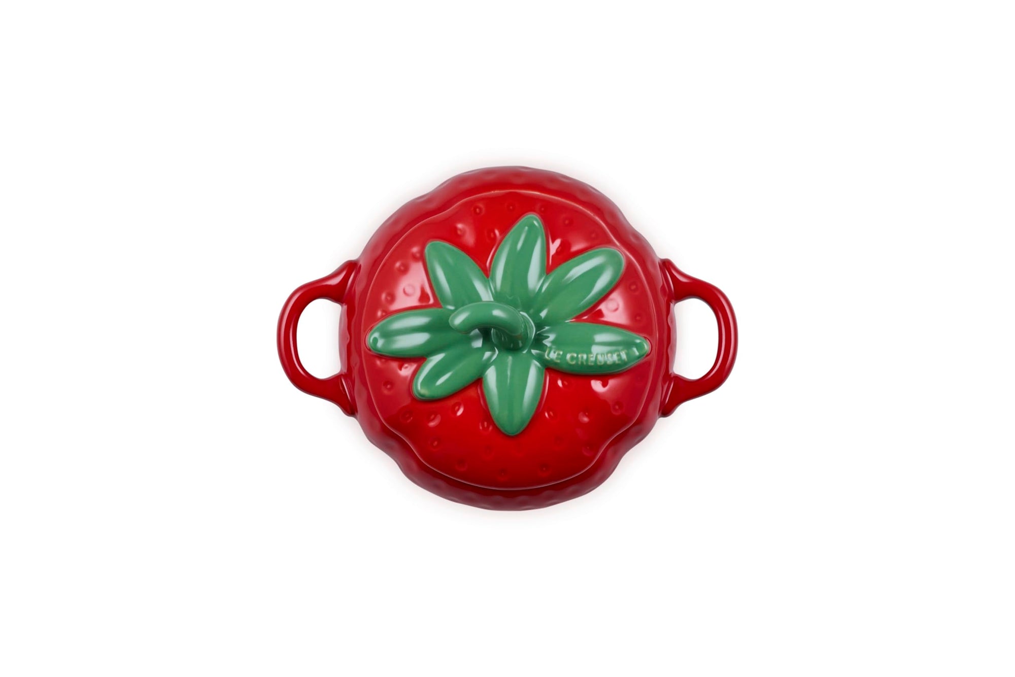 Top view of red ceramic pot shaped like a strawberry with green stem lid on a white background