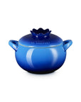 Side view of blue ceramic pot with lid that looks like a blueberry on a white background