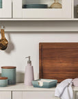 Le Creuset products on a kitchen counter in a kitchen setting