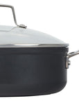 Side view of black cookware set with silver handle and lid on a white background