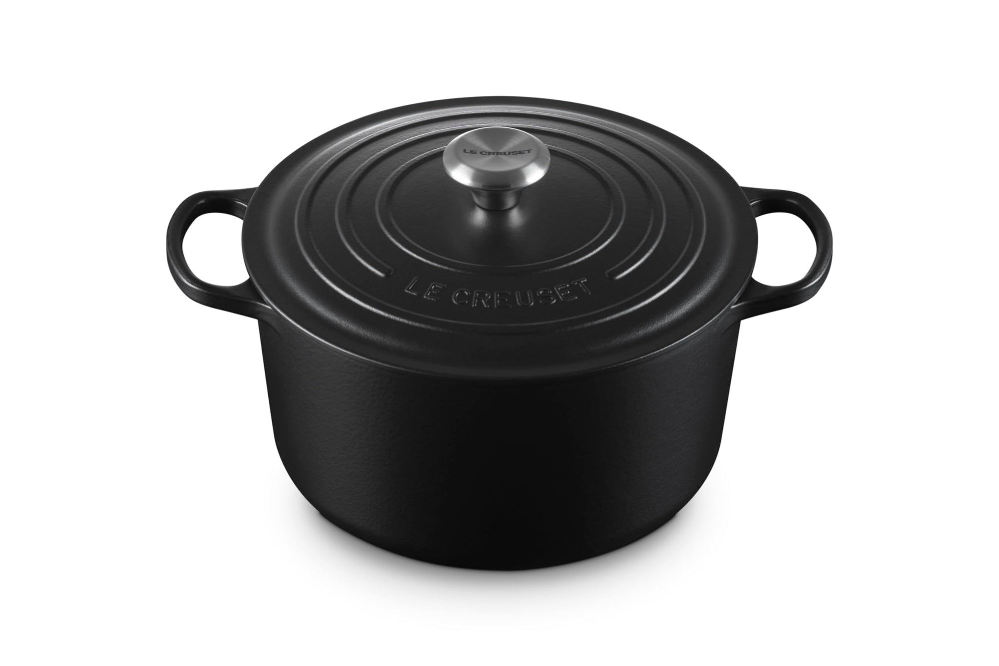 Black cast iron round oven with a lid and handles displayed on a white background