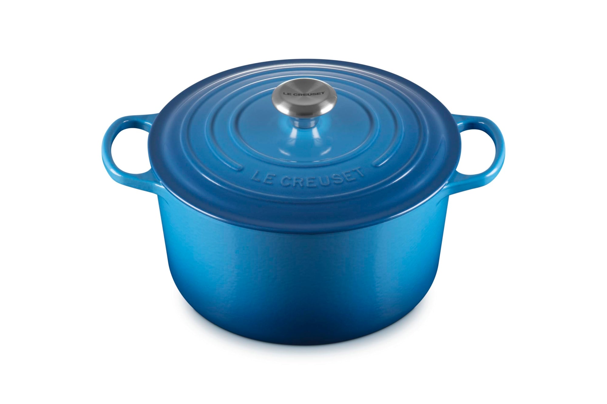 Blue cast iron Dutch oven with a lid on a white background