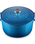Blue cast iron Dutch oven with a lid on a white background