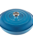 A Le Creuset blue enameled cast iron pot with a matching lid, featuring side handles and a silver knob, shown on a solid white background.