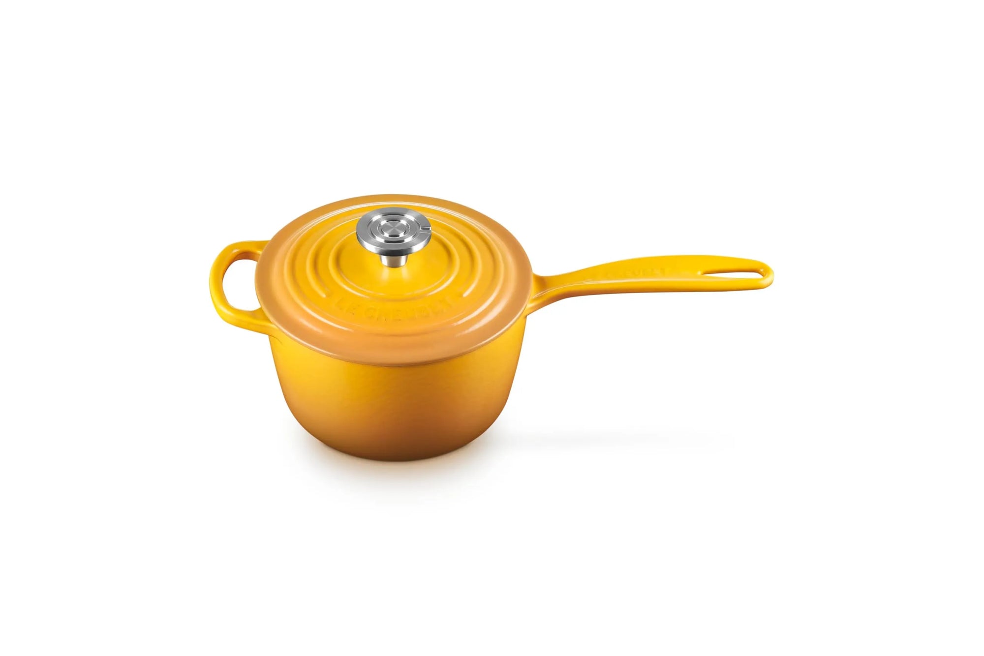 A small yellow enameled cast iron saucepan with a matching lid and a silver knob, set against a plain white background.