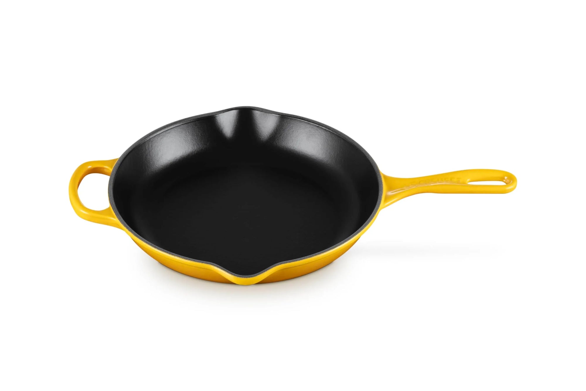 A yellow enameled cast iron skillet with a black non-stick interior, featuring a single loop handle on the left and a long straight handle on the right, shown on a white background.