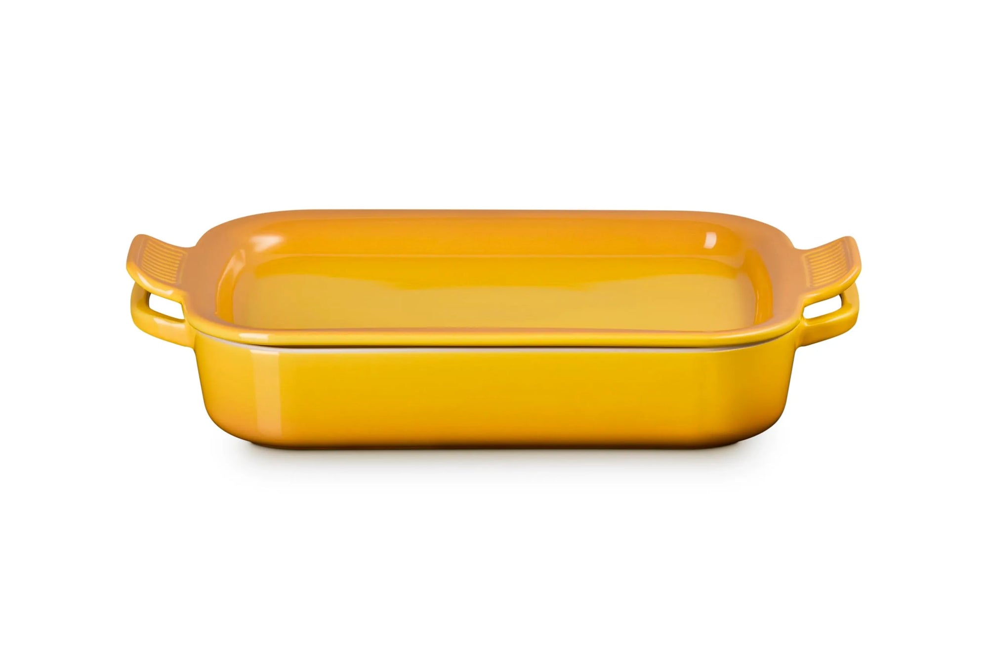 A rectangular yellow ceramic baking dish with side handles and lid, shown on a clean white background.