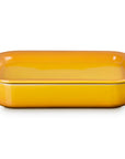 A rectangular yellow ceramic baking dish with side handles and lid, shown on a clean white background.