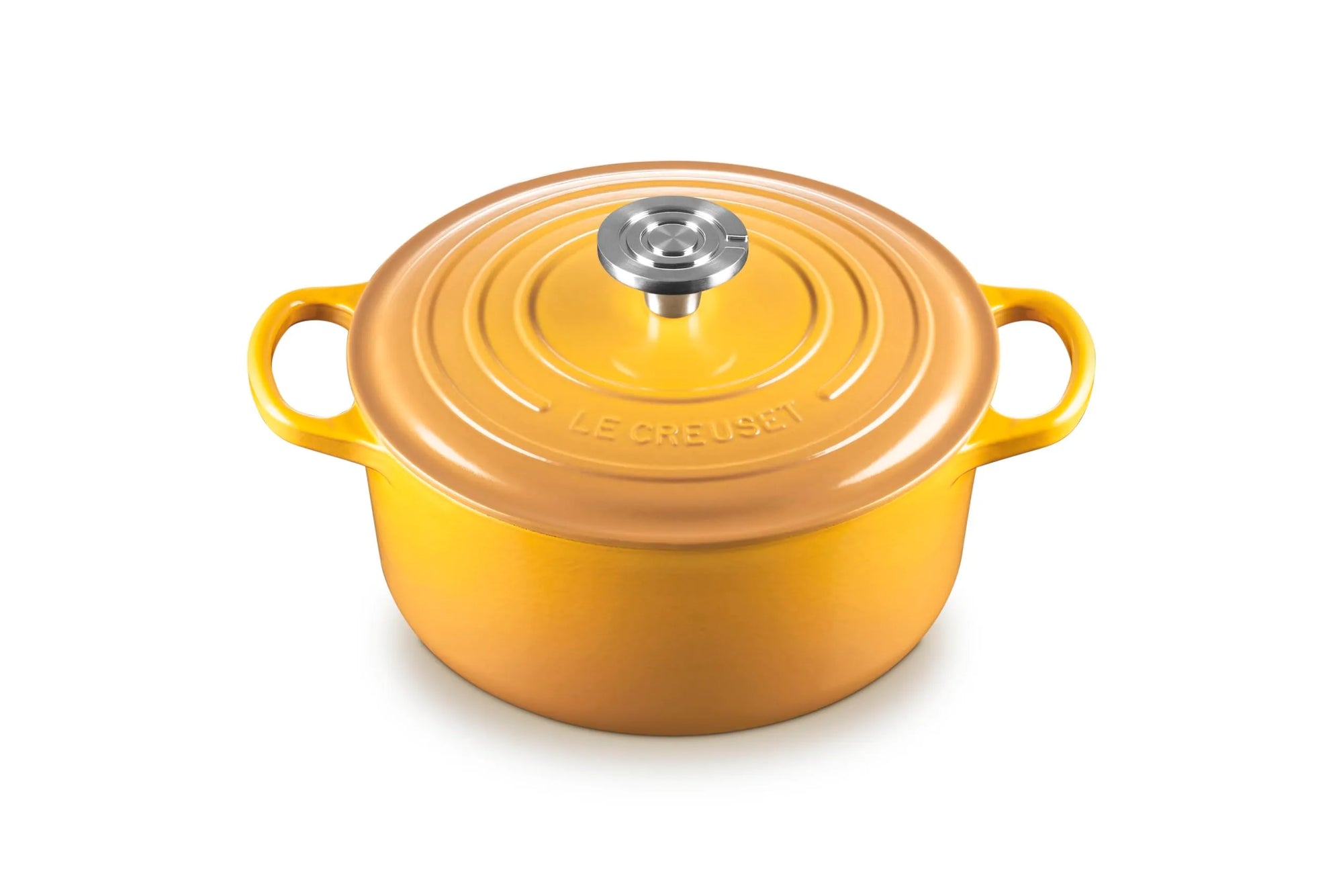 A yellow-orange enameled cast iron Dutch oven with a matching lid and side handles, featuring a silver knob, on a white background.