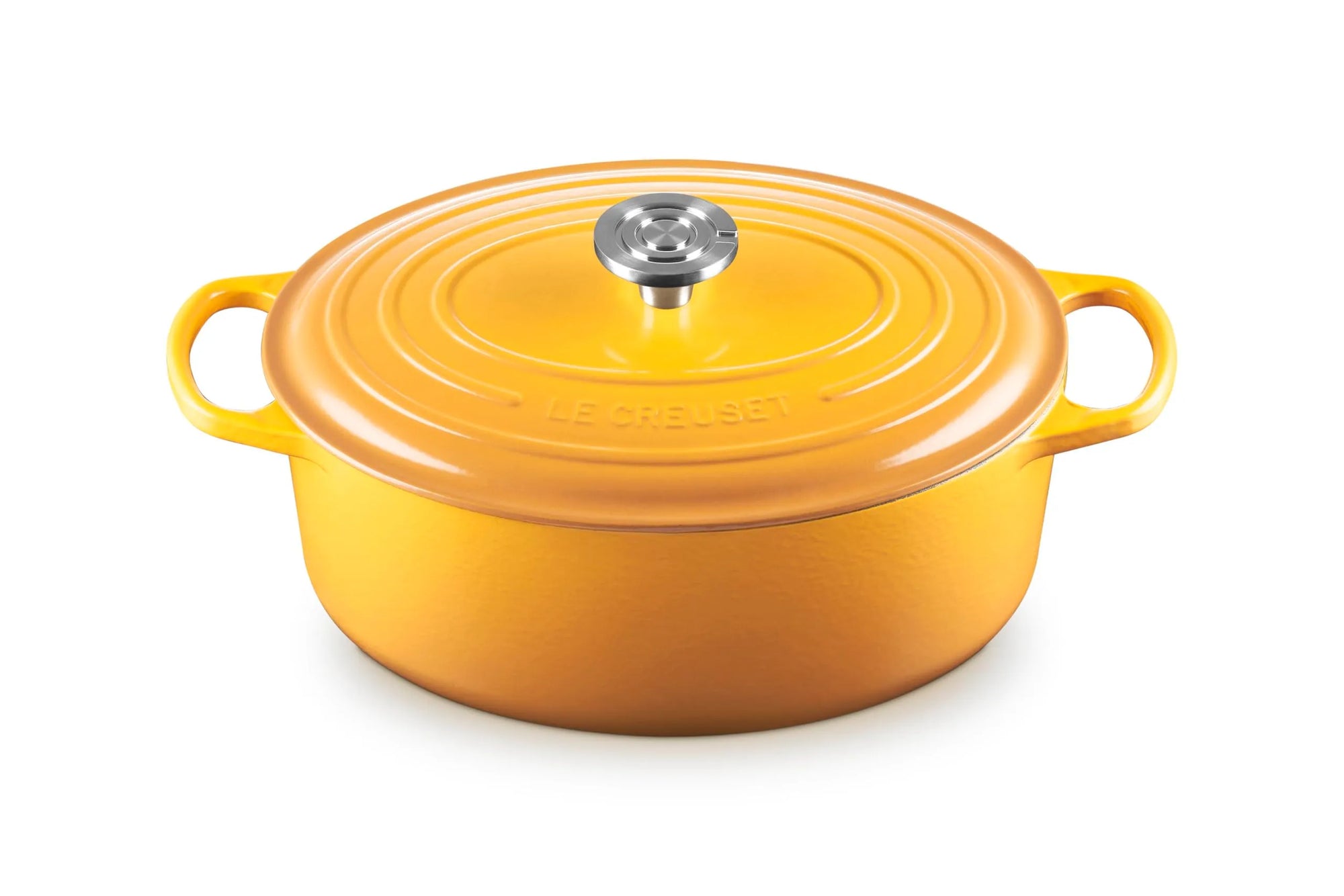 A Le Creuset round enameled cast iron Dutch oven with lid, in a vibrant orange-yellow color, featuring side handles and a silver knob, set against a plain white background.