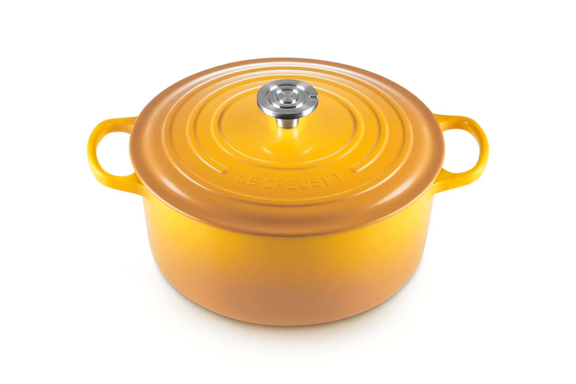 A yellow-orange enameled cast iron Dutch oven with a matching lid and side handles, featuring a silver metal knob, shown on a white background.