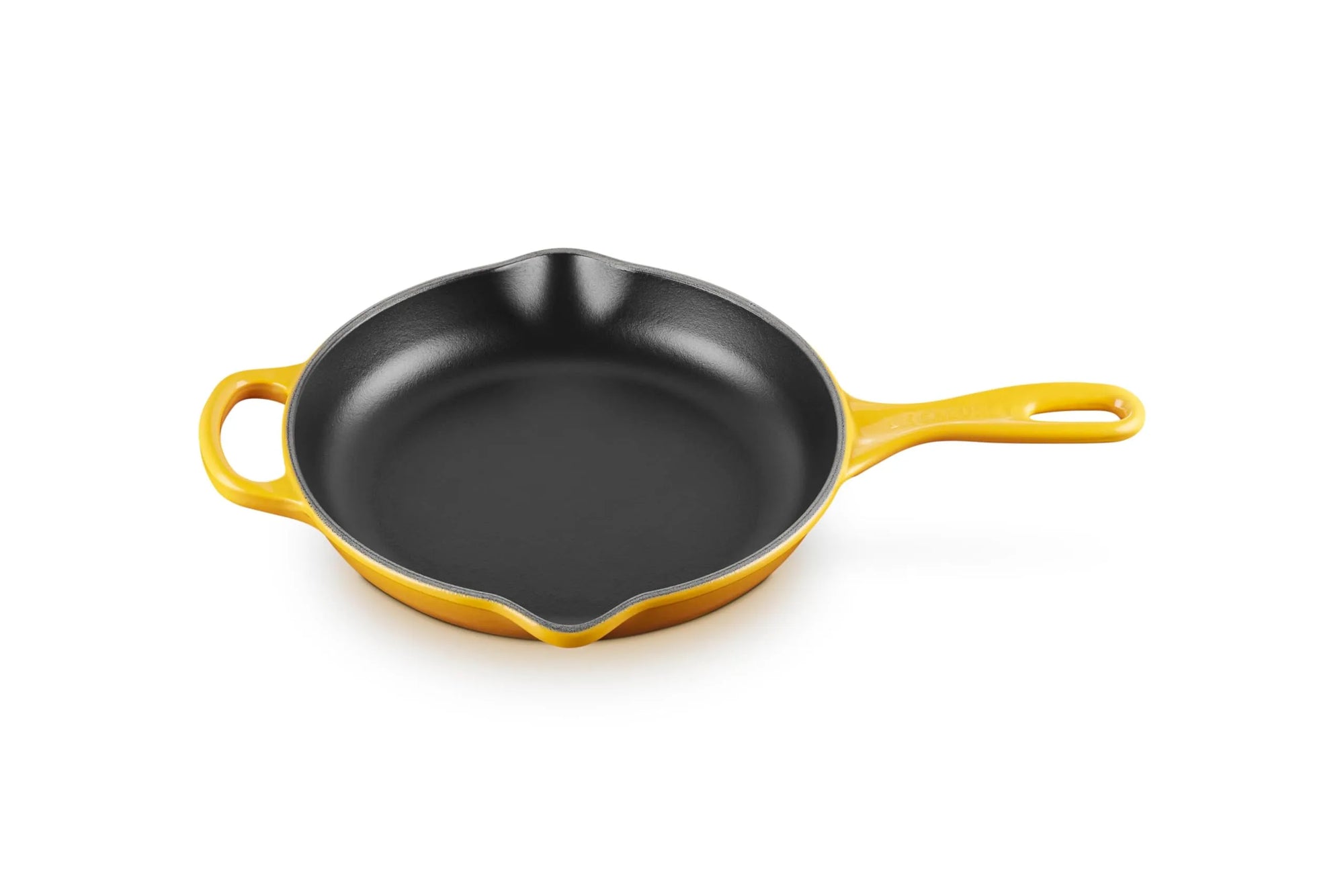 A yellow enameled cast iron skillet with a black non-stick interior, featuring a single loop handle and a small side handle, shown on a solid white background.