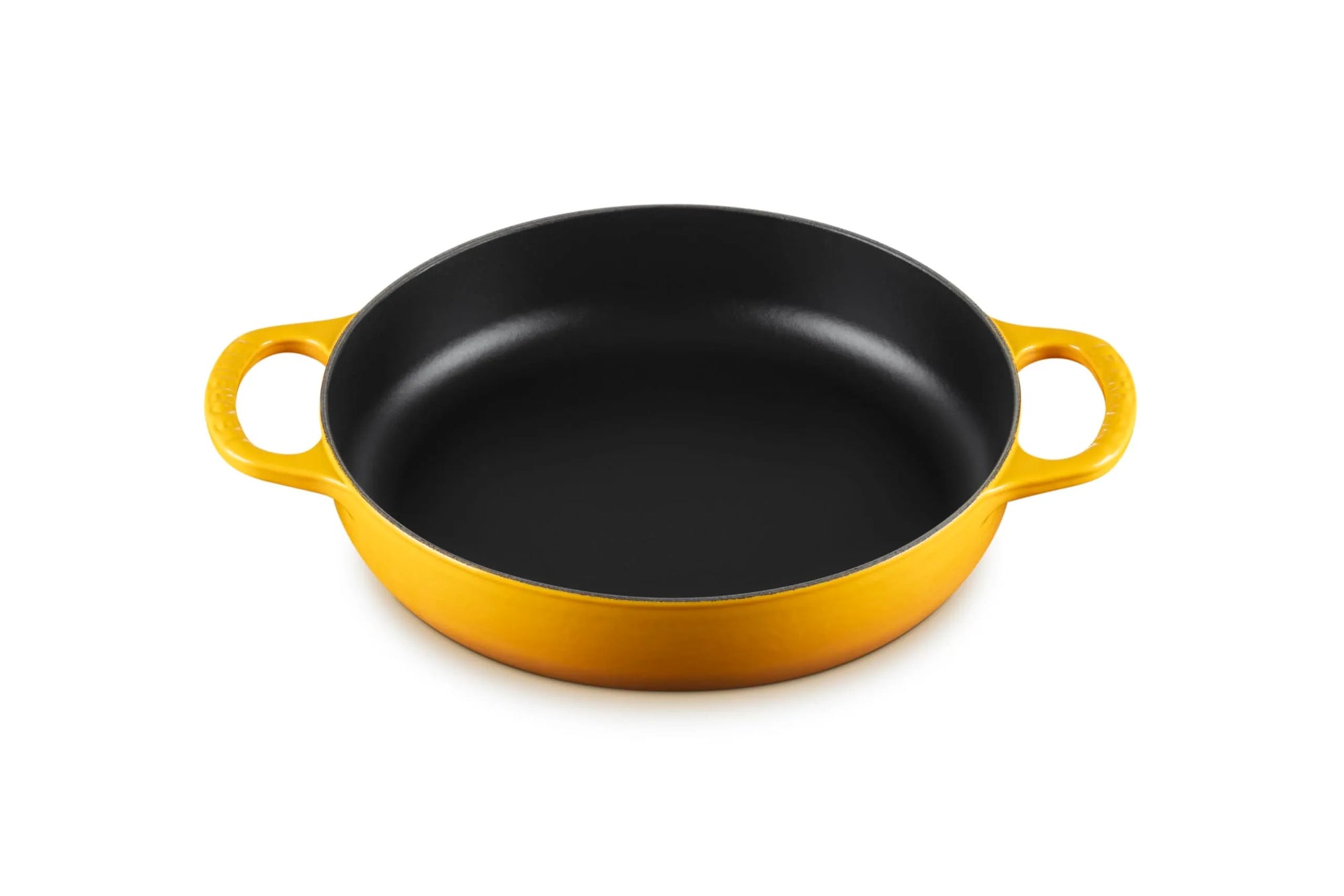 A round cast iron skillet with a yellow exterior and a black non-stick interior, featuring two loop handles on a white background.