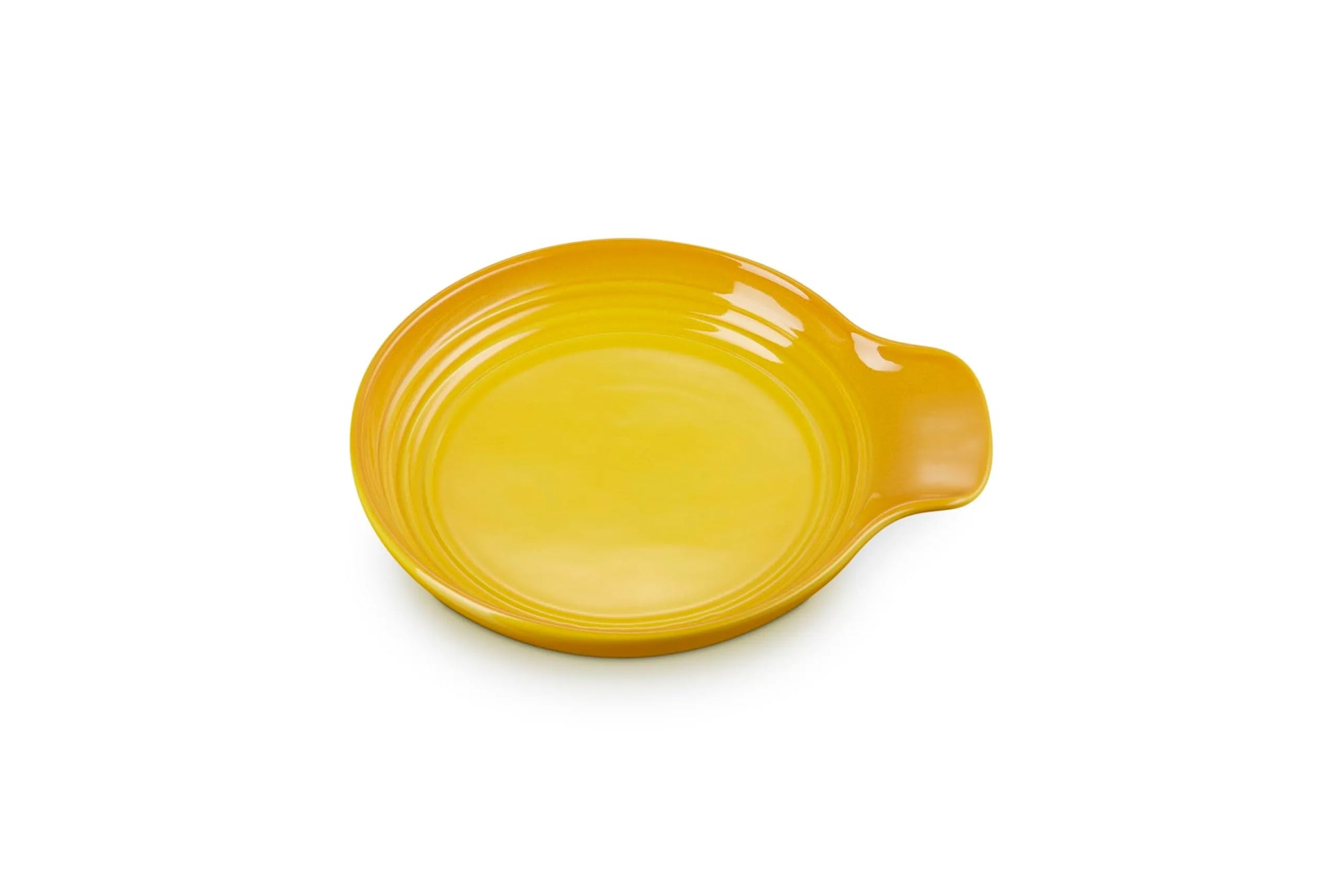 A bright yellow ceramic spoon rest with a small handle on the right side, shown on a plain white background.