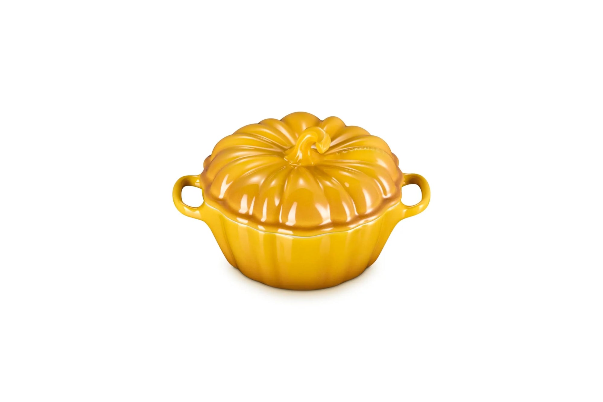 A glossy yellow-orange ceramic lidded casserole dish shaped like a pumpkin, featuring two side handles and a ribbed surface, set against a plain white background.