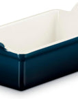 Dark blue Le Creuset 1.5 qt stoneware heritage loaf pan displayed on a white background