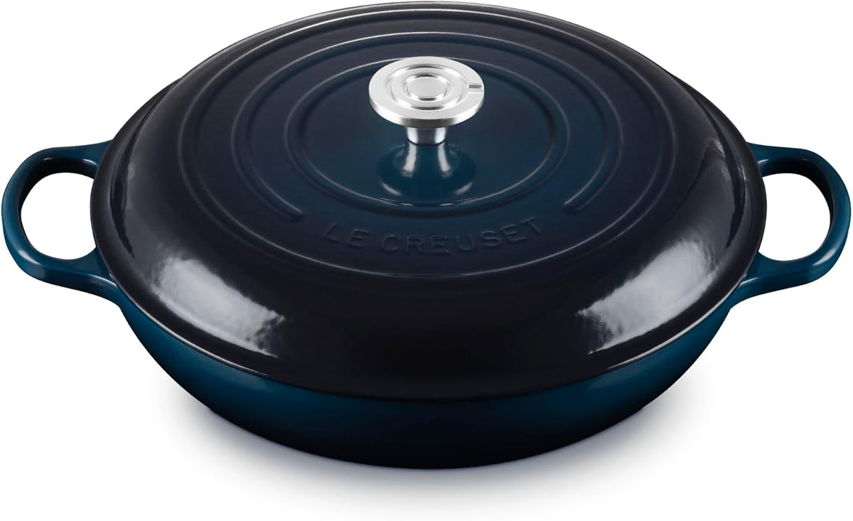 Dark blue Le Creuset 5 Qt. Signature Cast Iron Braiser displayed on a white background