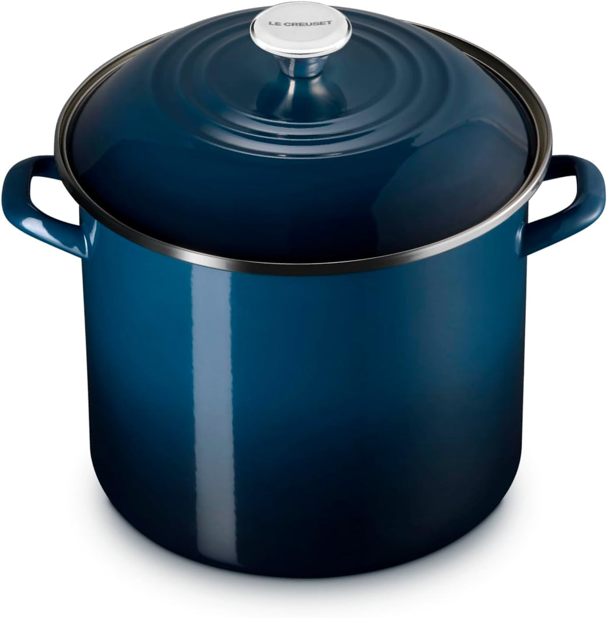 A dark blue enameled cast iron stockpot with a matching lid and side handles, shown on a clean white background.